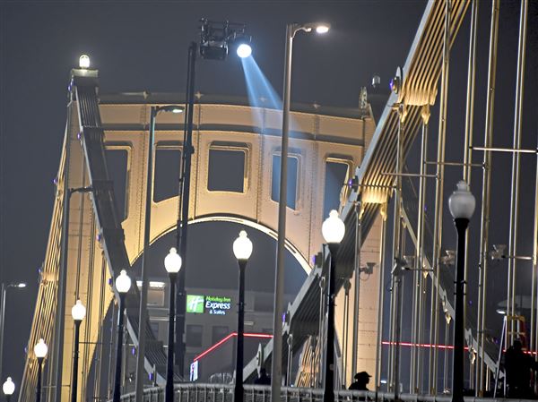 A spotlight is mounted on a lift on the Roberto Clemente Bridge in November 2-19. The bridge will be closed from 6 a.m. to 10 p.m. Monday for "How to Rob a Bank."