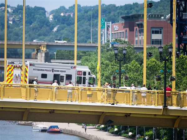 A Pittsburgh Police Bomb Squad truck sits on a closed Roberto Clemente bridge as film crews nearby work on "How to Rob a Bank," a new Amazon MGM Studios movie, on Monday, June 23.