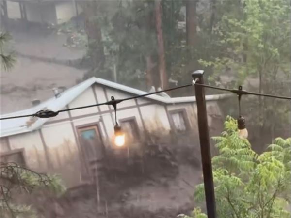 In this image taken from video, a house is carried away by flash flooding Tuesday, July 8, 2025, in Ruidoso, N.M.
