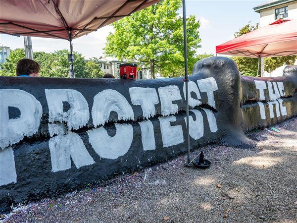 Carnegie Mellon University students sit under canopies and guard The Fence to protect their message to President Trump on Sunday, July 13, 2025.  The students said they plan to stay there until the president comes to visit on Tuesday.  The Fence is an iconic, student-centered space for free expression and community at CMU.