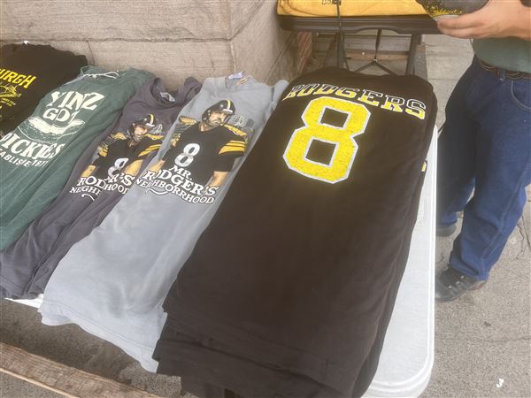 A set of Aaron Rodgers T-shirts sit outside Yinzers in the Burgh in the Strip District. The shirts are some of the store's top sellers.