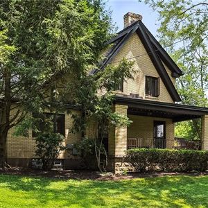 There is a large covered porch at the front of the house at 115 Forest Hills Road in Forest Hills.