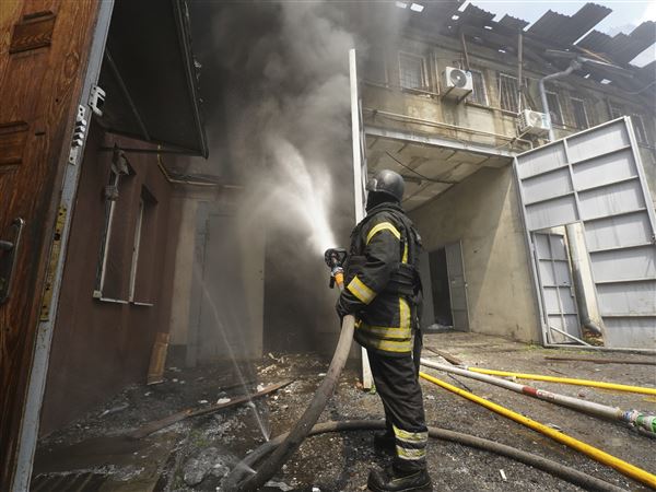 Firefighters tackle the blaze after a Russian attack that hit a residential area in Kharkiv, Ukraine, Thursday, July 24, 2025.