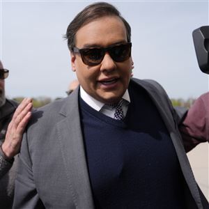 Former U.S. Rep. George Santos arrives at federal court for sentencing April 25 in Central Islip, N.Y. Santos reported to a federal prison in New Jersey on Friday to begin serving a seven-year sentence for the fraud charges that got him ousted from Congress