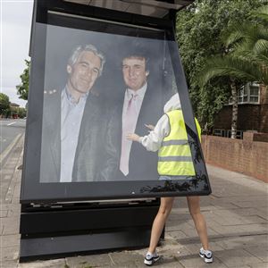 Activists put up a poster showing President Donald Trump and Jeffrey Epstein near the U.S. Embassy in London, Thursday, July 17, 2025.