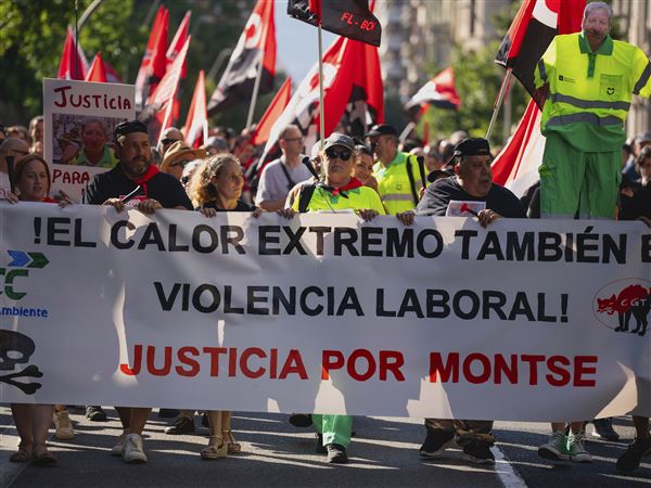 FILE - People march in Barcelona to protest the death of street cleaner Montse Aguilar during a recent heat wave in Spain, Wednesday, July 16, 2025. The banner in Spanish reads, “Extreme Heat is also Workplace Violence. Justice for Montse."