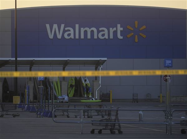 Police tape is seen outside a Walmart where multiple people were stabbed in a violent attack Saturday, July 26, 2025, in Traverse City, Mich