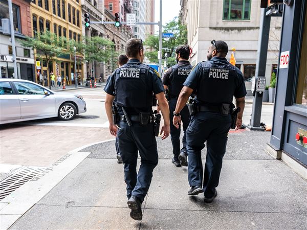 Pittsburgh patrol officers  Jaelen Gramz, left, and Duane Burgwin follow James Verbitsky, front left, and Youssif Almansawi as they walk the beat Downtown on Wednesday, Aug. 6, 2025.  