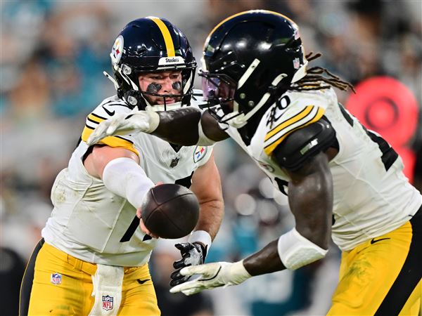 Skylar Thompson of the Pittsburgh Steelers hands the ball off to Kaleb Johnson in the first half during the NFL Preseason 2025 game between the Pittsburgh Steelers and the Jacksonville Jaguars at EverBank Stadium on August 09, 2025 in Jacksonville, Florida. 