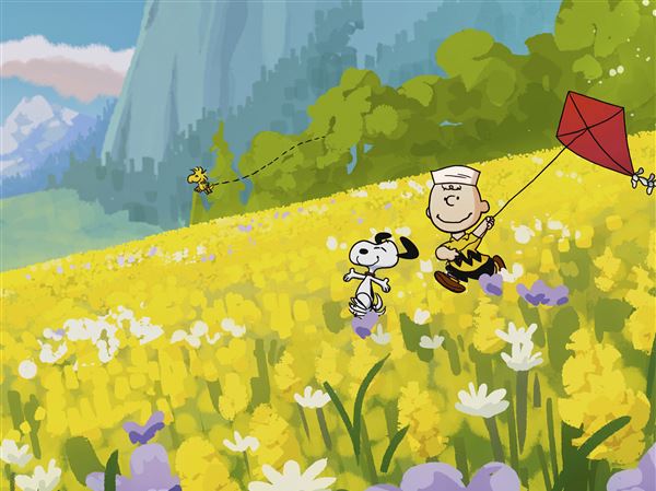 Peanuts characters Snoopy and Charlie Brown run through a field in "Snoopy Presents: A Summer Musical."