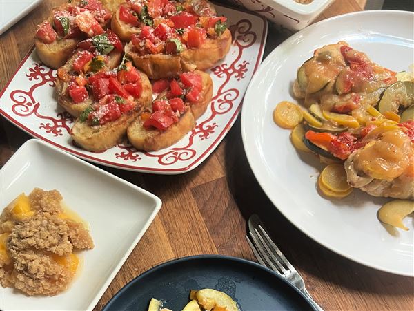 This budget summer dinner for four includes bruschetta, chicken and seasonal vegetables in a foil packet and peach crisp for dessert.