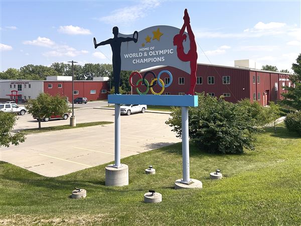 Years after abuse reports, ex-coach at renowned U.S. gymnastics academy is arrested by FBI