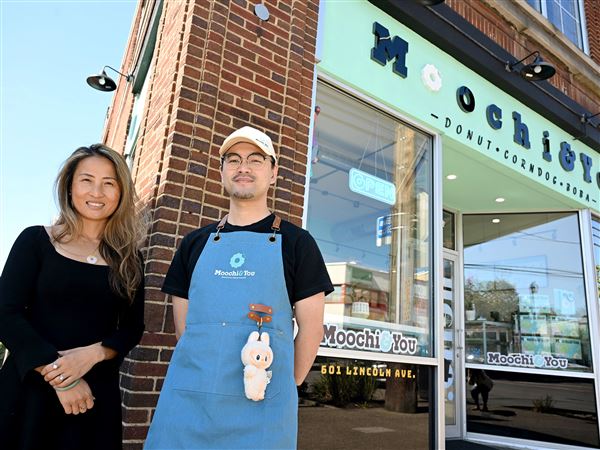 Owners Jia Jia Manuel, left, and Weixiang You outside Moochi & You in Bellevue.