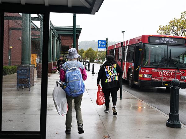 Riders head to the Pittsburgh Regional Transit bus in front of the Giant Eagle at the Waterfront in Homestead on Thursday, Sept. 25, 2025.  PRT confirmed this stop will be eliminated.